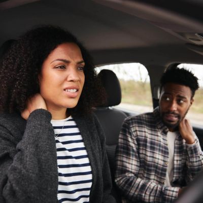 a man and a woman sitting in a car