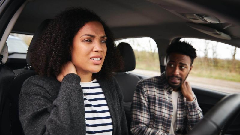 a man and a woman sitting in a car