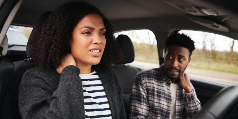 a man and a woman sitting in a car