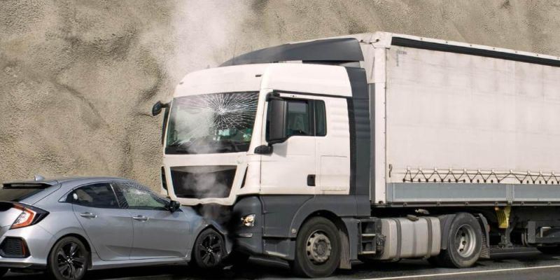 A car positioned in front of a tractor-trailer