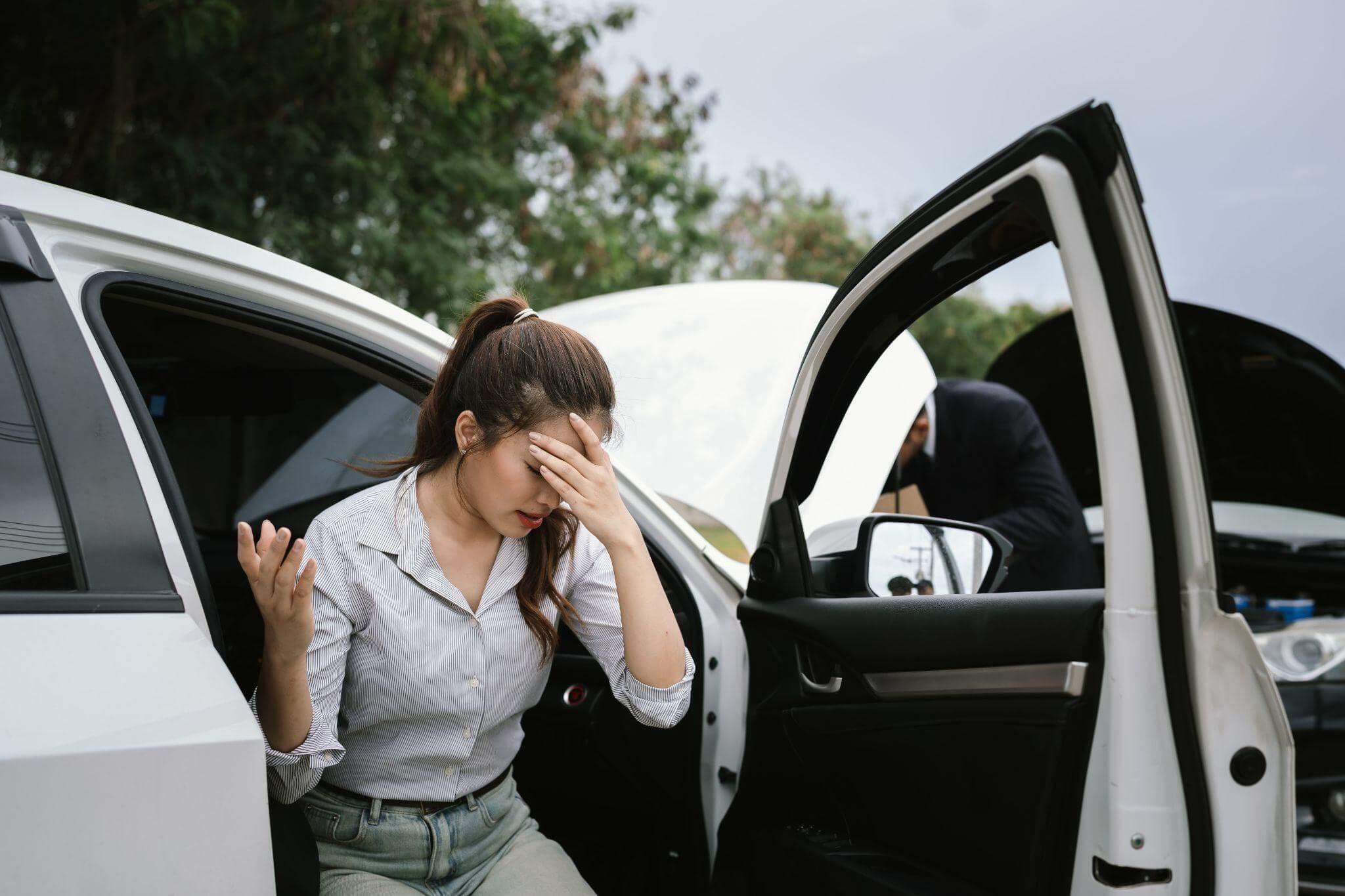 a woman sitting in the back of a white car