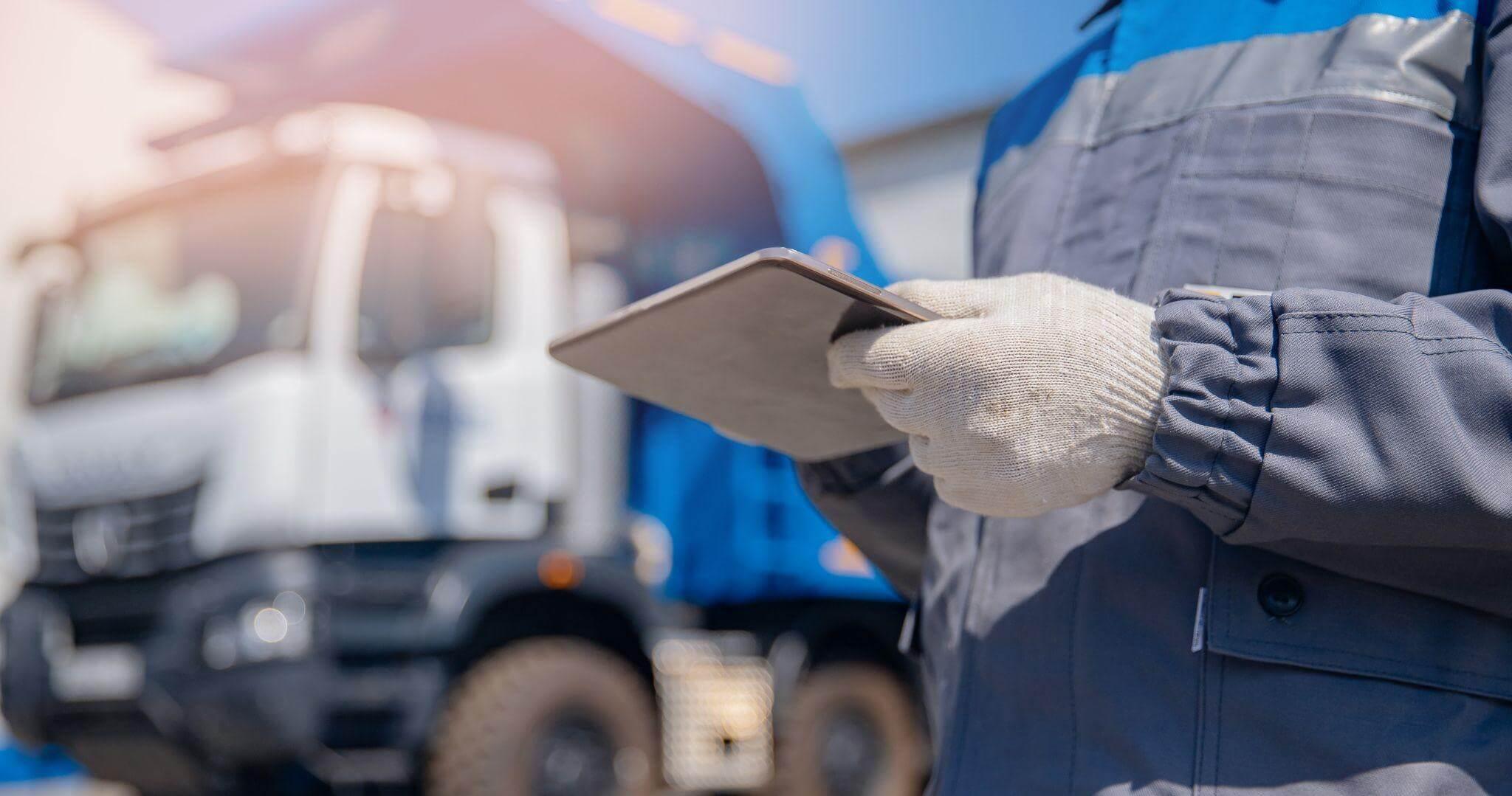a man holding a clipboard in front of a truck
