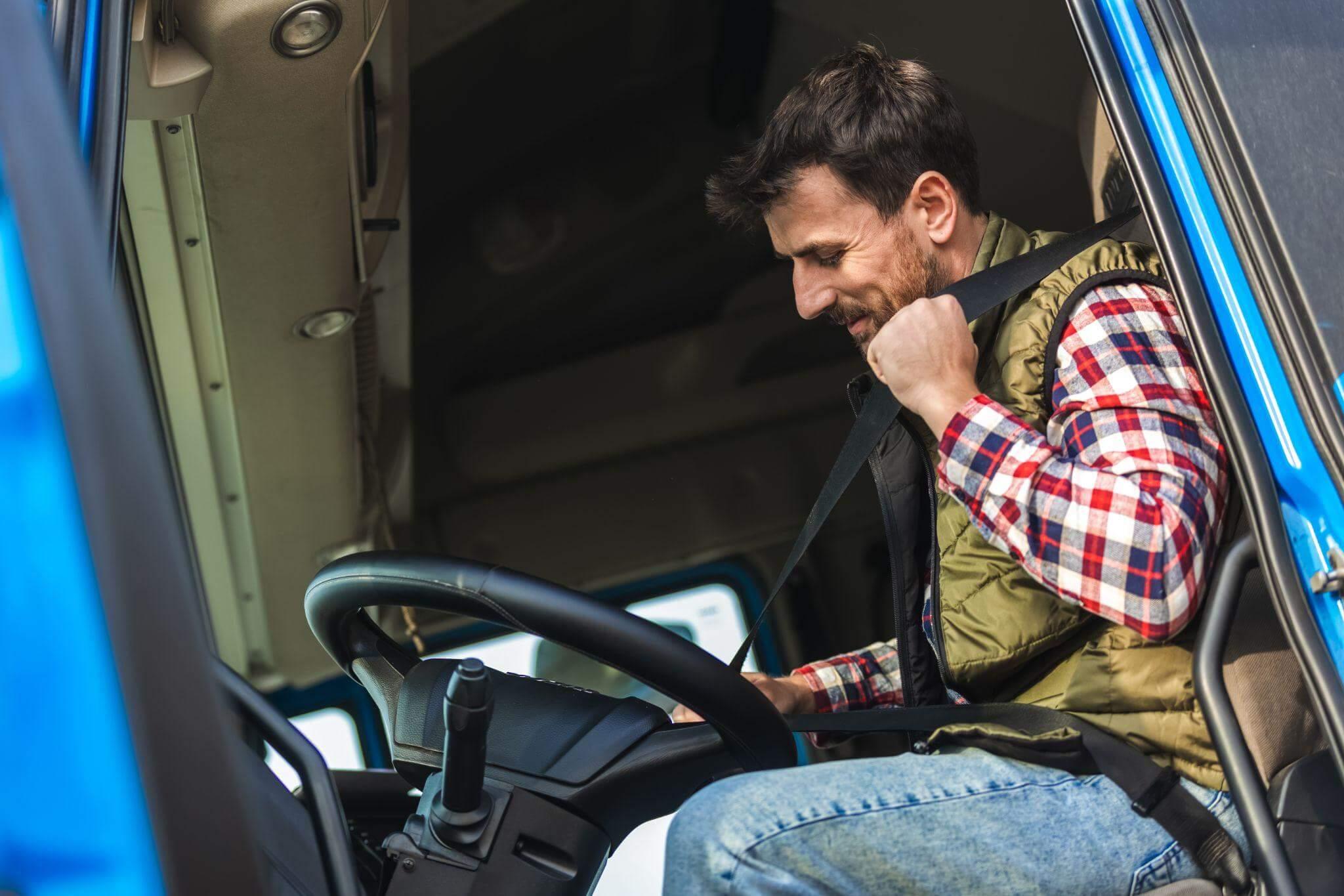 a man sitting in the driver seat of a truck