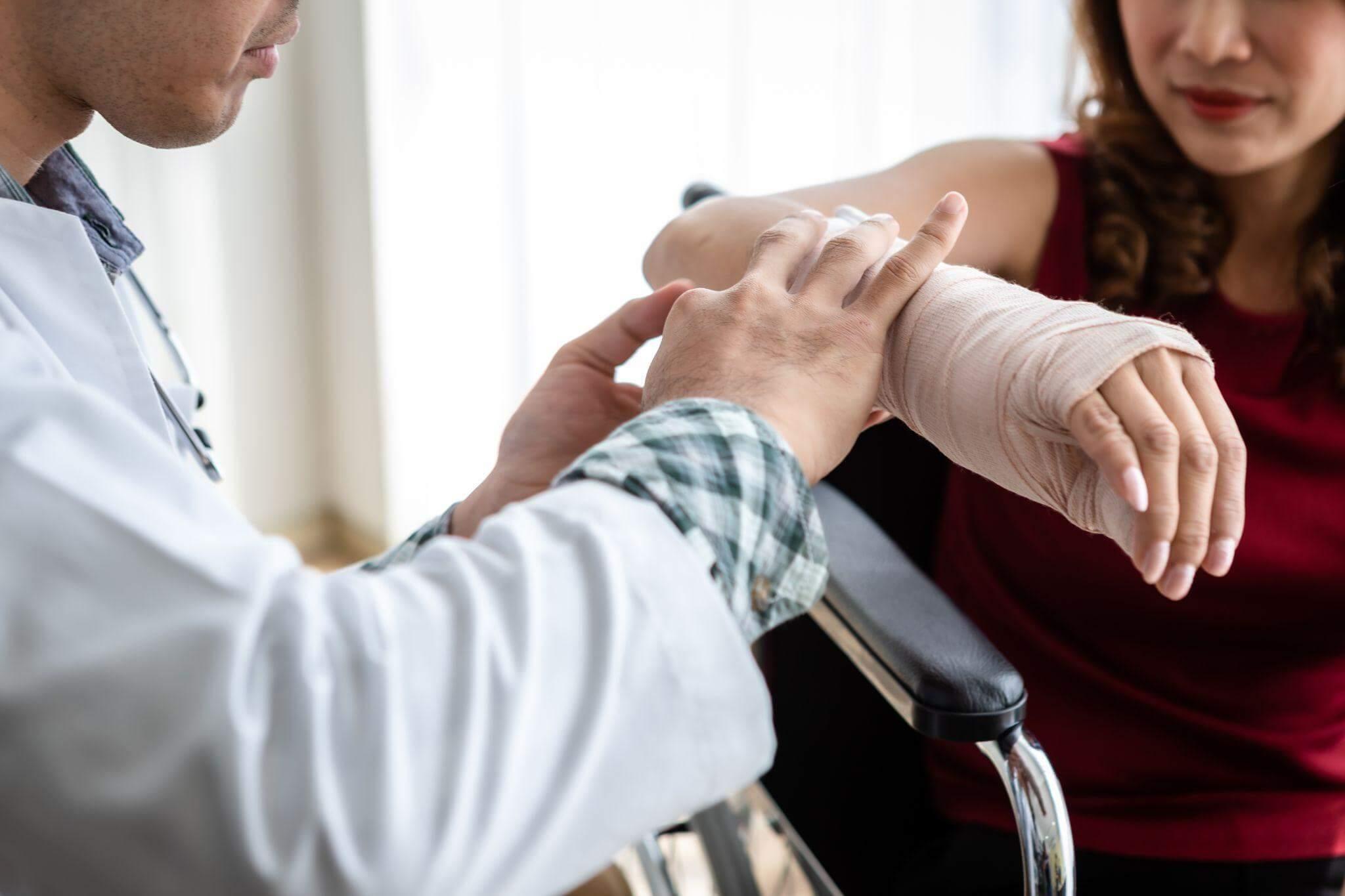Woman bandages man in wheelchair, illustrating immediate care after